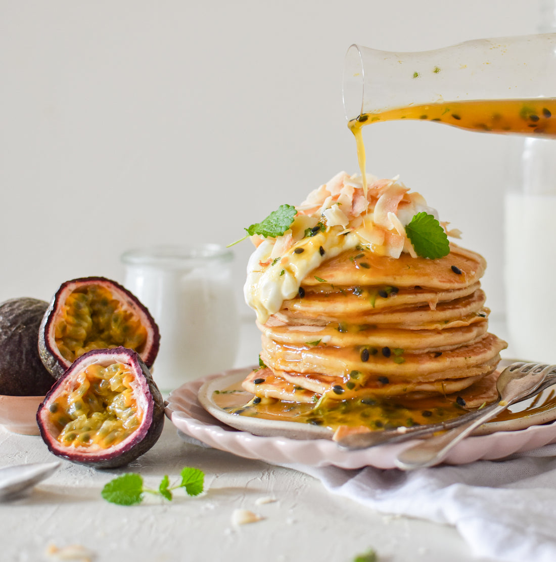 Coconut pancakes with passionfruit syrup and lemon balm